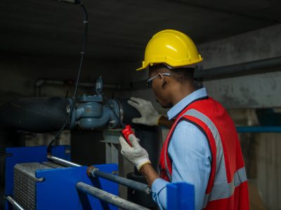 worker-inspecting-water-valve-for-leaks-in-basemen-2023-07-17-22-02-21-utc-min-scaled